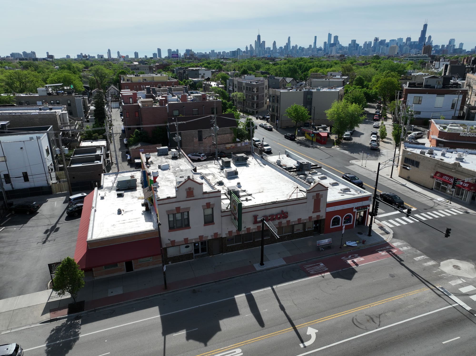Aerial photograph of a commercial corner property with the Chicago skyline on the horizon.